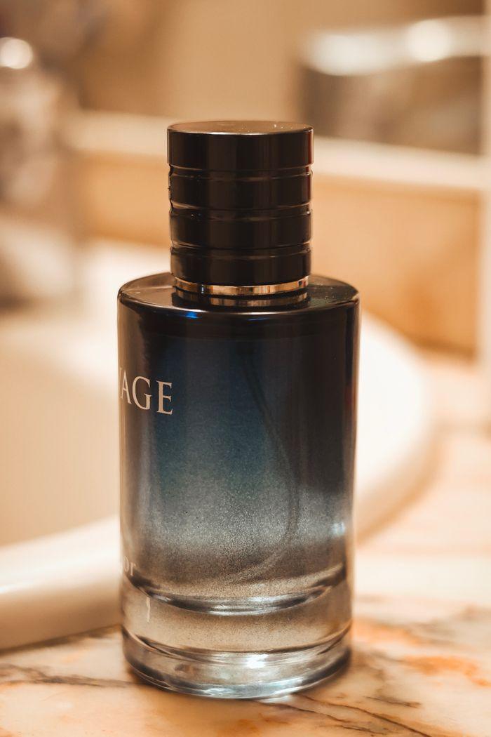 hero-gallery-04 Close-up image of an elegant perfume bottle on a marble countertop, showcasing luxury and style.