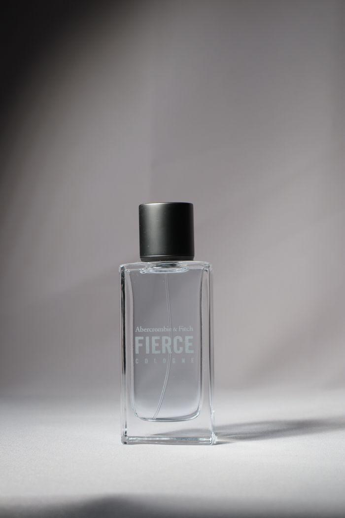 programs-02 Minimalist photo of a perfume bottle showcasing simplicity and elegance.