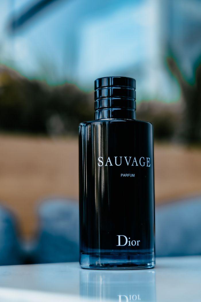 gallery-img-06 Stylish Dior Sauvage perfume bottle, elegantly displayed outdoors with a blurred background.