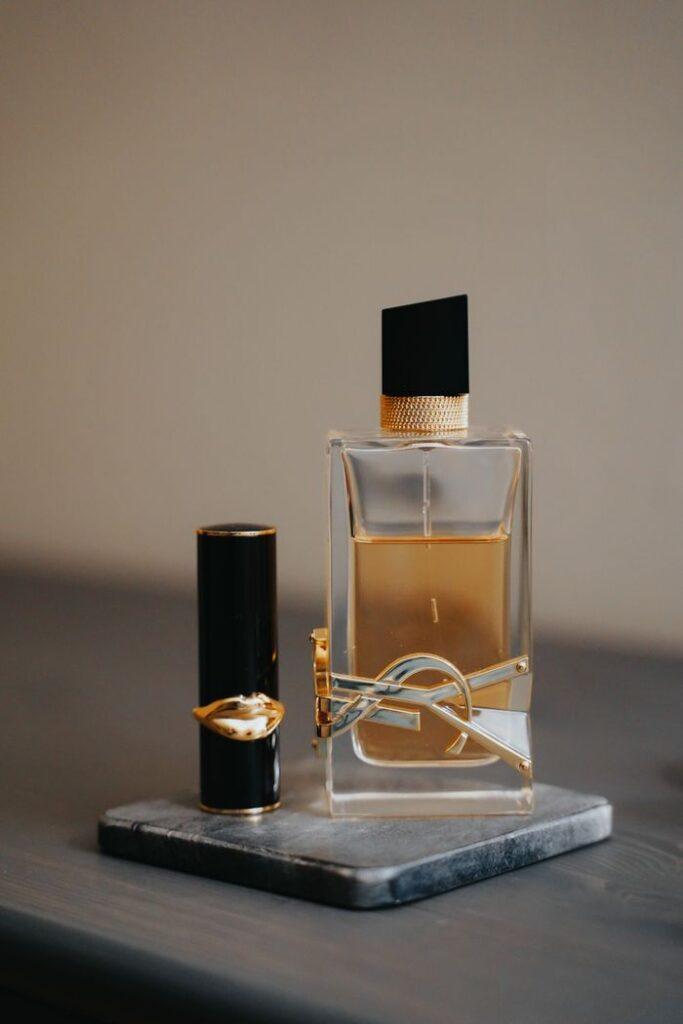A close-up of luxury perfume and lipstick showcasing elegance and style. Perfect for fashion and beauty themes.